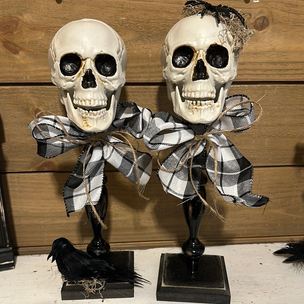 Skull heads on spindles (flannel bow)
