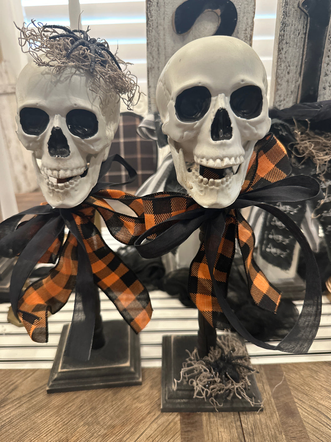 Set of 2 skull heads on spindles