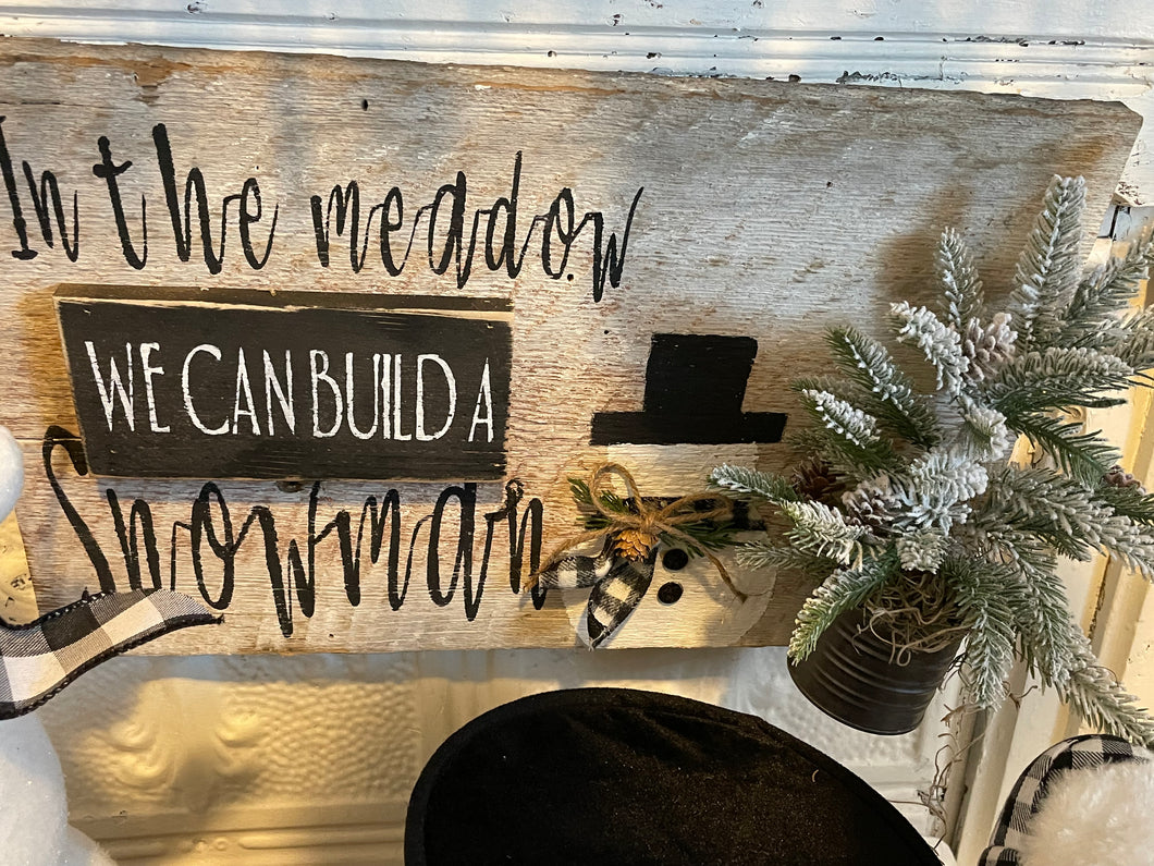 In the meadow snowman sign