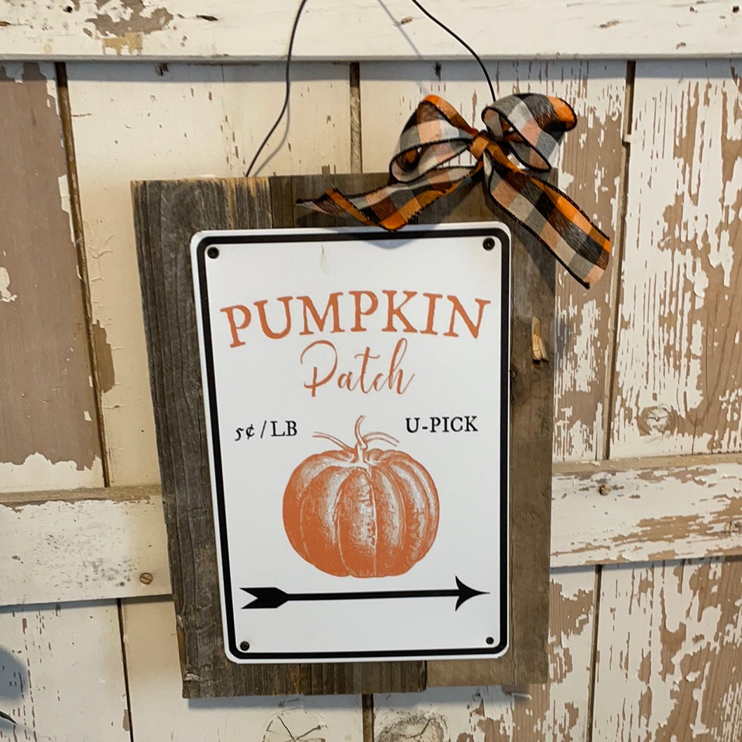 Pumpkin metal sign on wood
